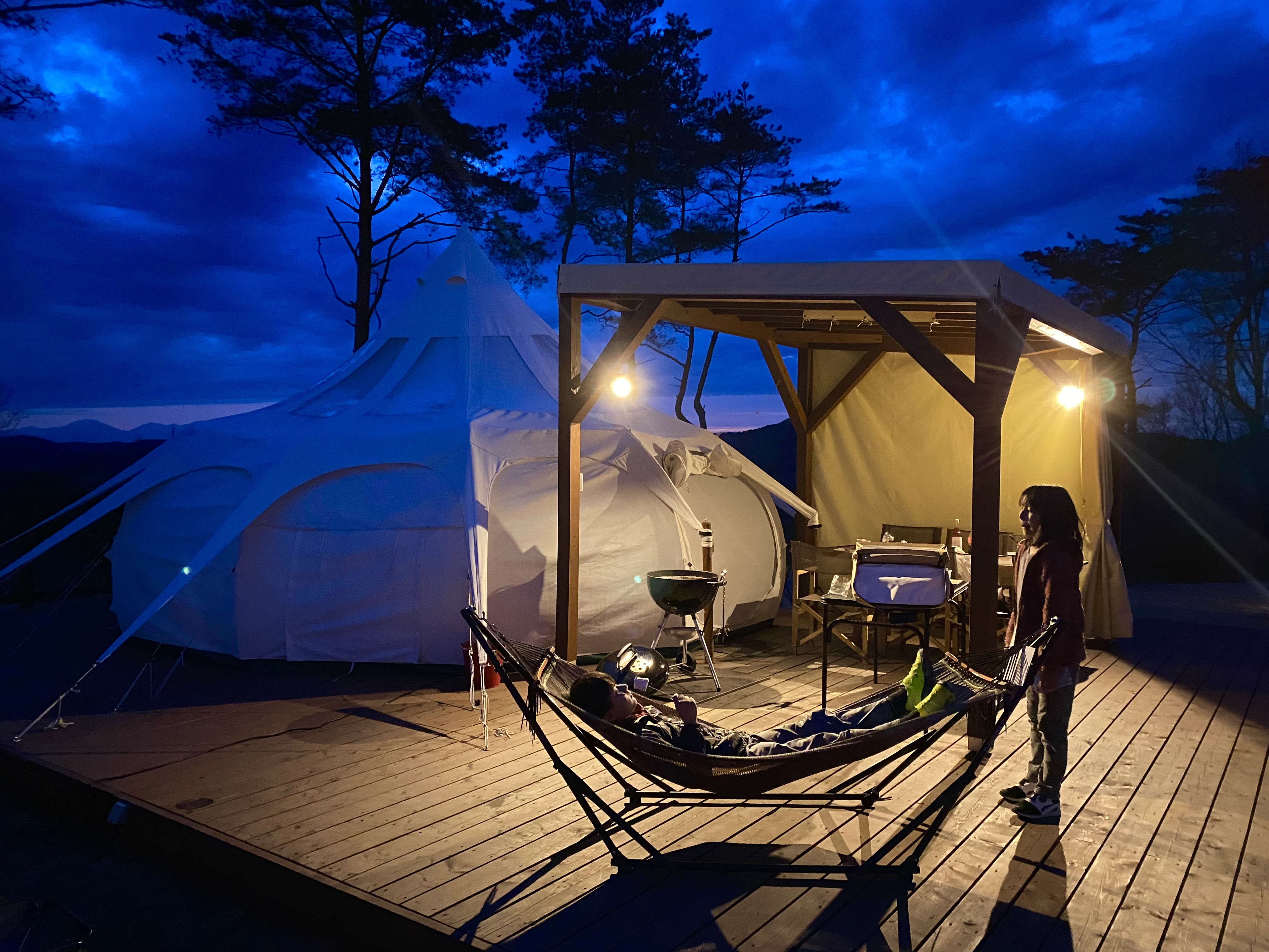 Lotus glamping tent glowing at night at Motegi Mobility Resort