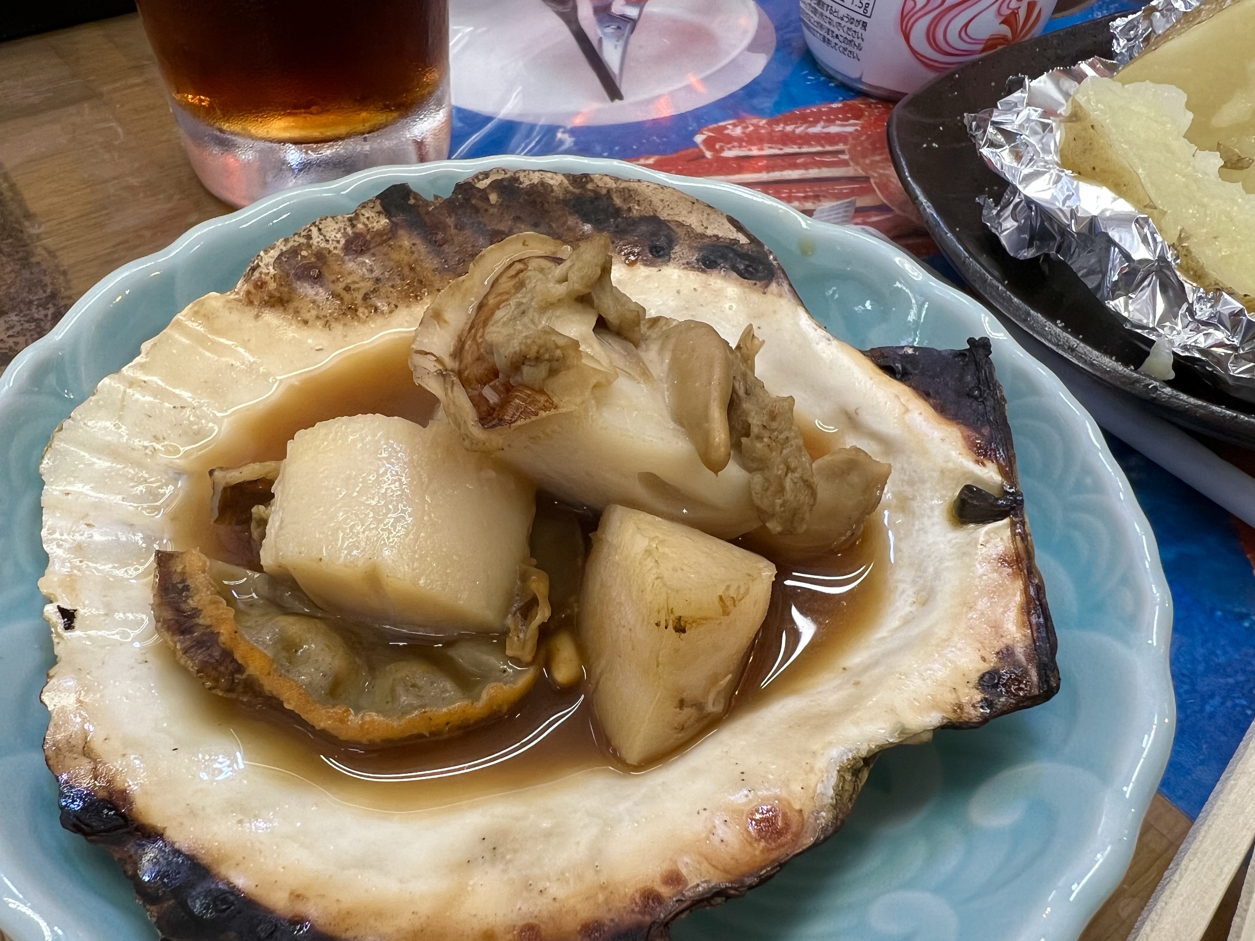 Grilled Hokkaido scallop served in its shell with butter and soy sauce at an Otaru street stall